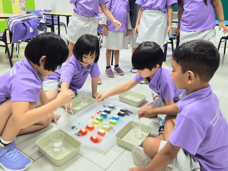 Children exploring colours with rainbow ice activity